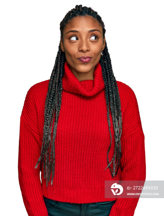 African american woman wearing casual winter sweater smiling looking to the side and staring away thinking.