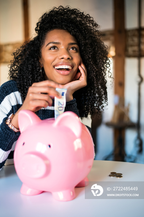 Black woman with saving piggy bank