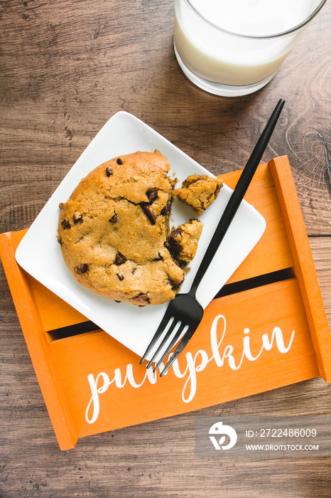 pumpkin chocolate chip cookies on wooden table