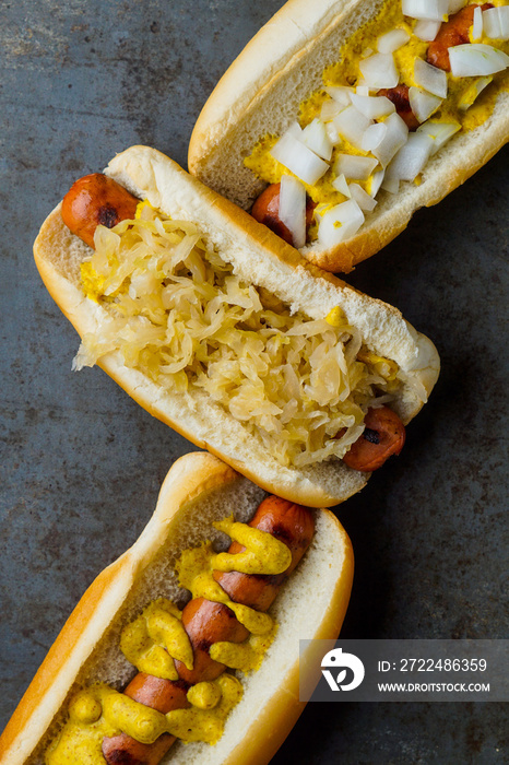 Grilled hot dogs with mustard, sauerkraut and onions