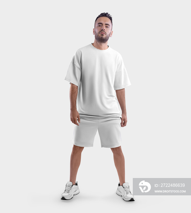 Oversized white t-shirt template, shorts on posing bearded guy in sneakers, front view, isolated on background.