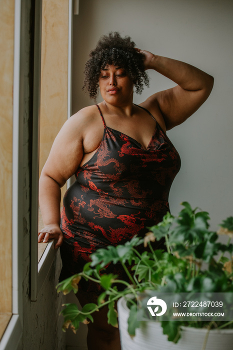 portrait of a plus size afro indigenous person looking down eyes closed