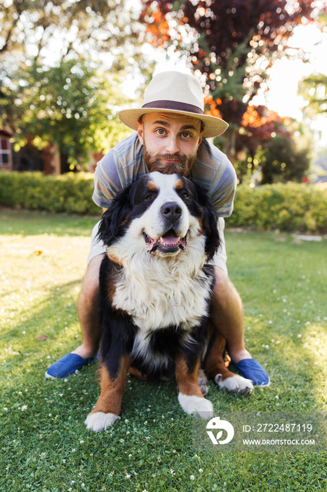 Man hugging a big black dog