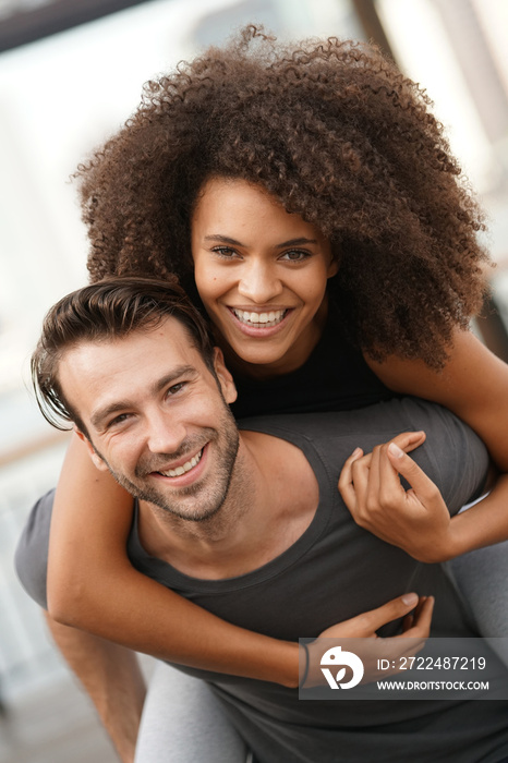 Man giving piggyback ride to girlfriend