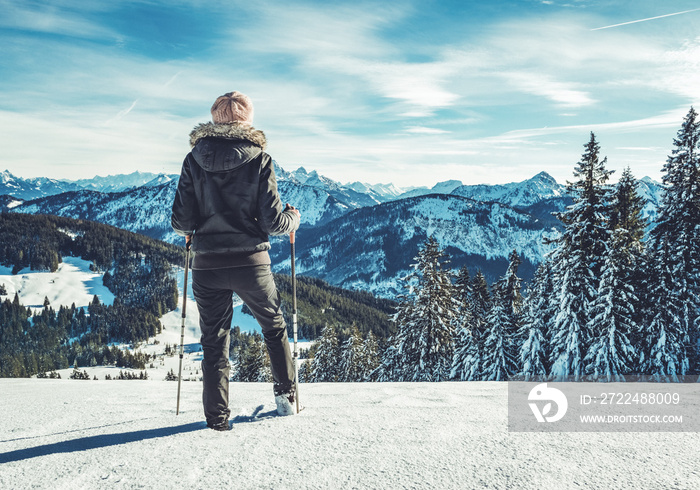 woman standing on top of mountain in snow