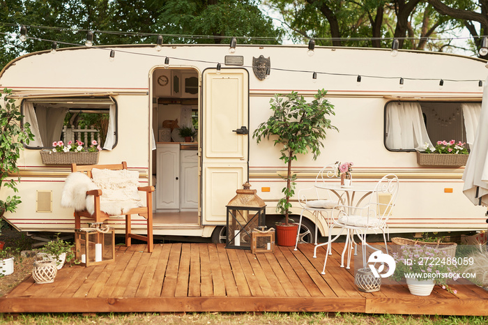 Van mobile home on green grass in summer at sunset, House on wheels