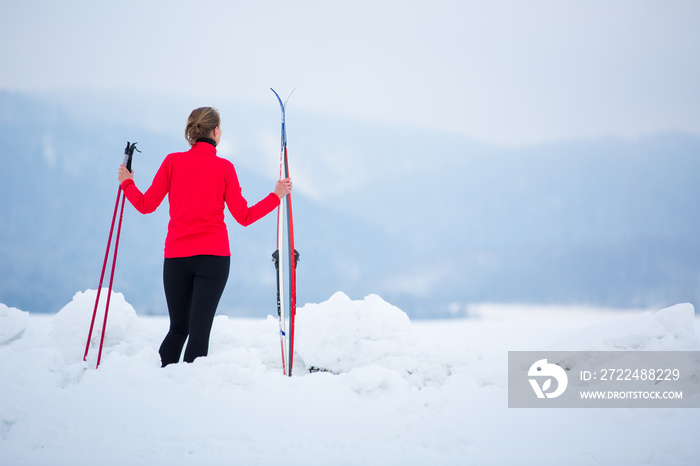 Cross-country skiing: young woman cross-country skiing on a  winter day (motion blurred image)