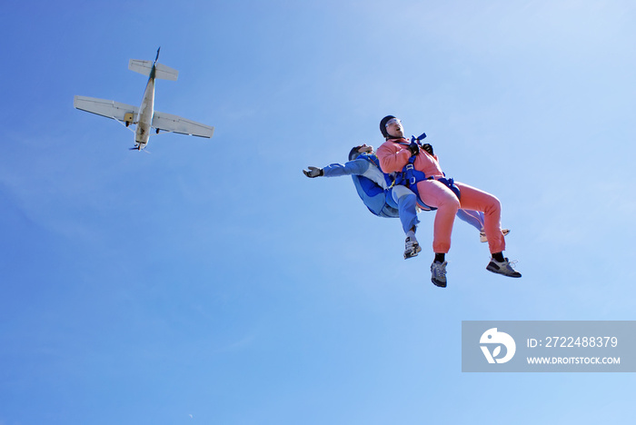 Sky dive tandem jump with blue background