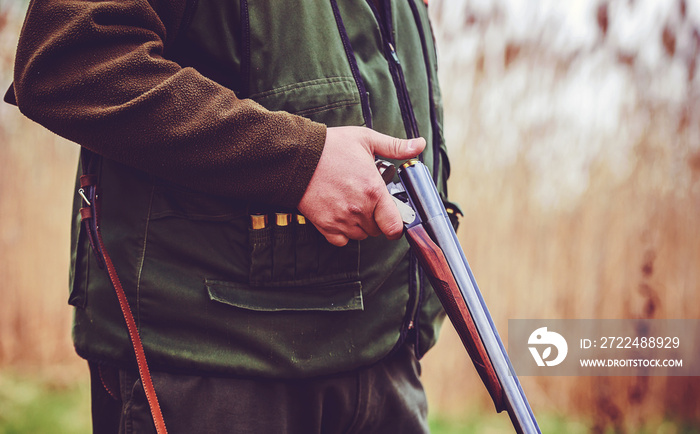 Hunter with a rifle in hunting