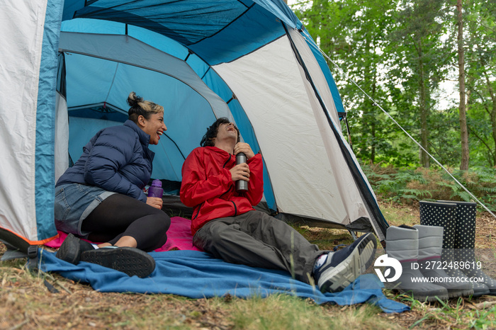 Mother and son camping in forest