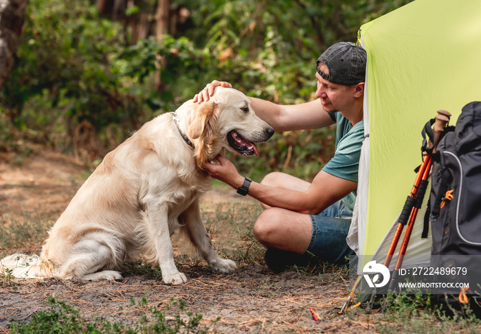 Man with dog next to tent