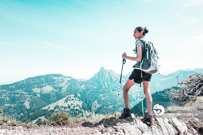 Athletic fit young woman hiking in the mountains