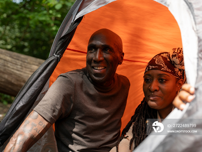 Mature couple relaxing in tent after hike