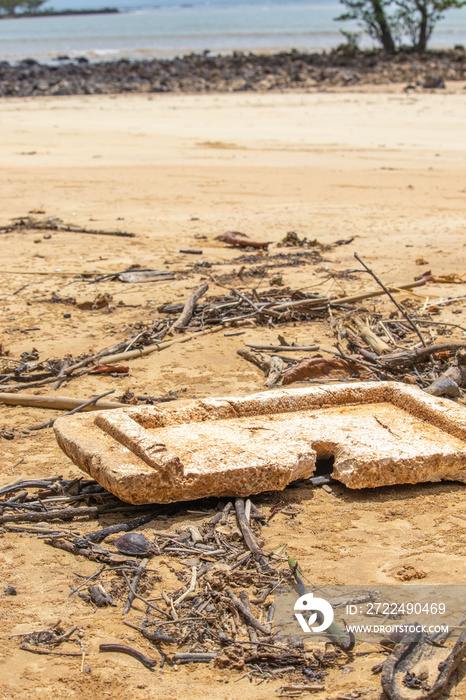 EPS foam - polystyrene board polluting the environment on a beach