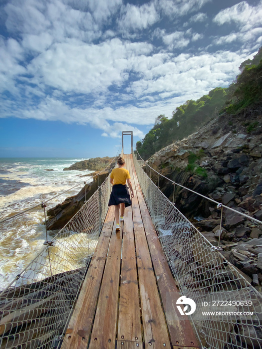 Woman on suspension bridge at Tsitsikamma National Park, South Africa.