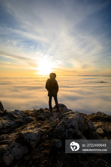 Man on top of mountain watching the sunset