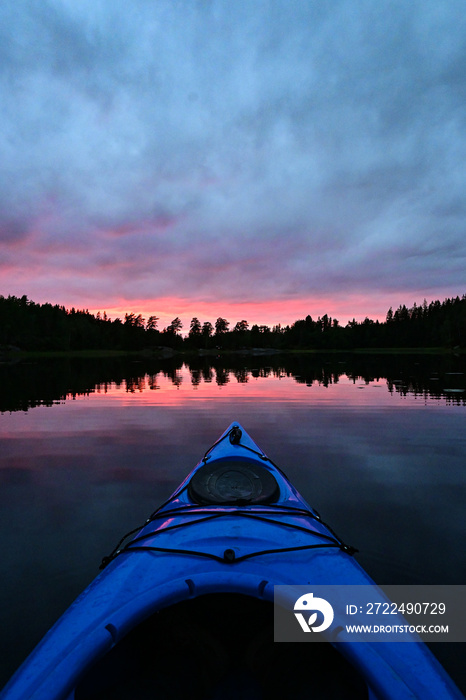 First person view from Kayak on a natural Norwegian lake in a magical sunset evening