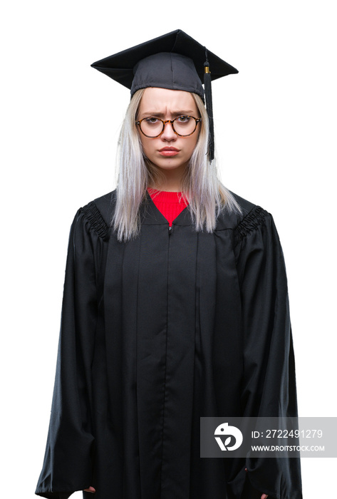 Young blonde woman wearing graduate uniform over isolated background skeptic and nervous, frowning upset because of problem. Negative person.