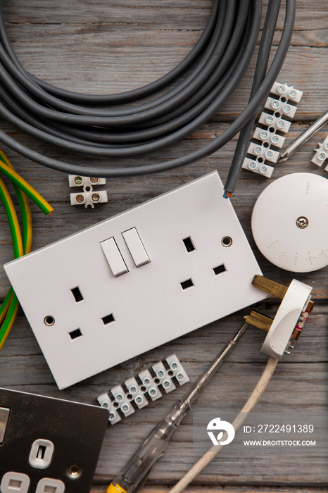 Electrical tools and equipment on a wooden background