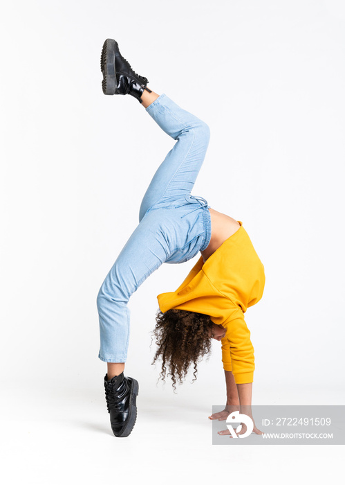 Young African American woman dancing over isolated white background