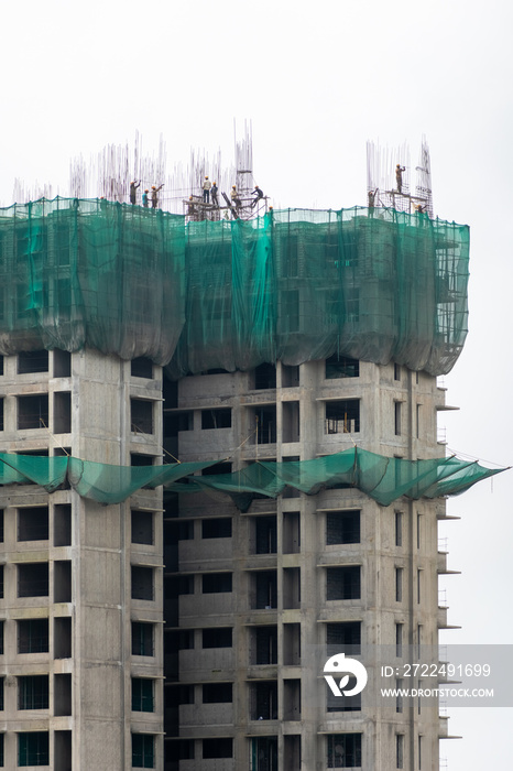 Safety nets and scaffolding on a tall high rise building under construction in the city of Mumbai.