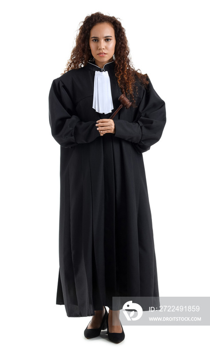 Young female judge with gavel on white background