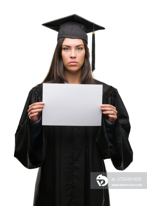 Young hispanic woman wearing graduated uniform holding diploma paper with a confident expression on smart face thinking serious