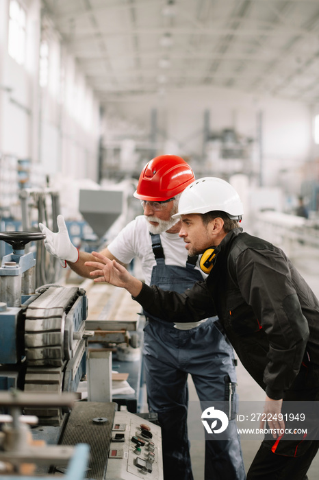 Colleagues working together. Workers in factory.