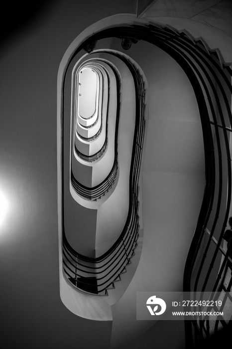 Black and white photo of old spiral staircase, spiral stairway inside old house in Budapest, Hungary