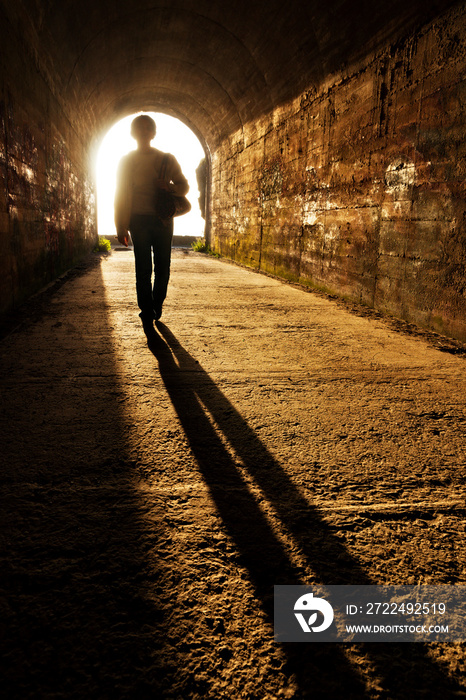 brave woman  without fear in tunnel with light in background