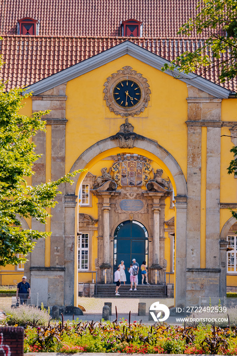 famous European university in a beautiful yellow palace building in the Baroque architectural style.