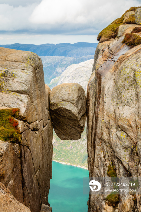 Kjeragbolten, the stone stuck between two rocks with fjord in the background, Lysefjord, Norway