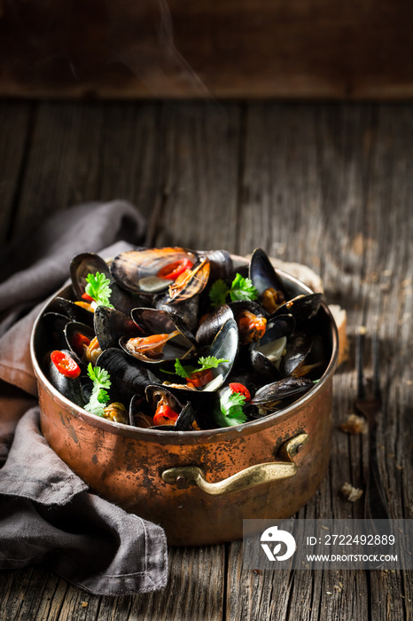 Tasty and fresh mussels with coriander and chili peppers