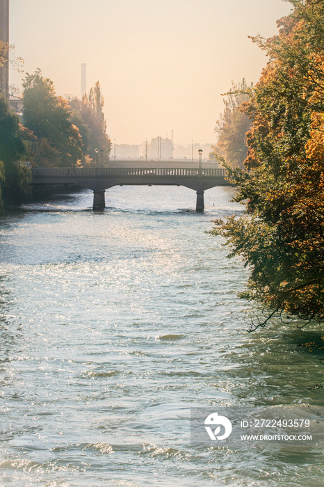 Munich, Bosch bridge on Isar river autumnal view in a sunny foggy day