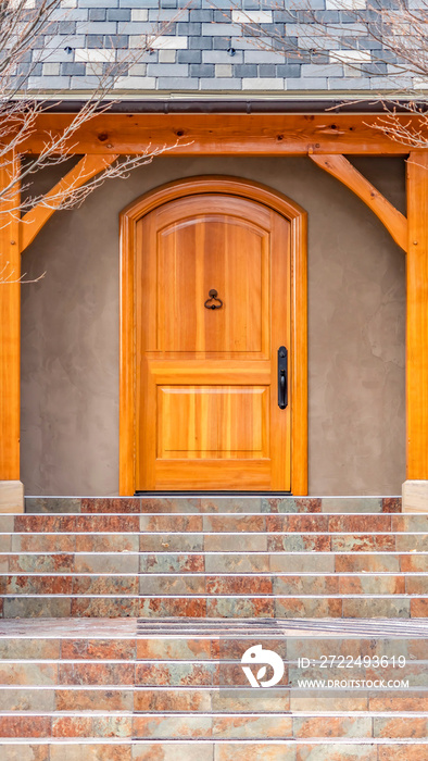 Clear Vertical Entryway of home framed with leafless hibernating trees on the yard in winter