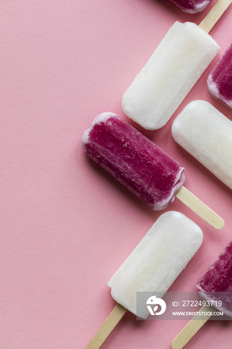 pink and white summer ice lollies on a pink background