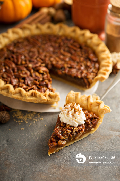 Pecan pie topped with whipped cream for Thanksgiving