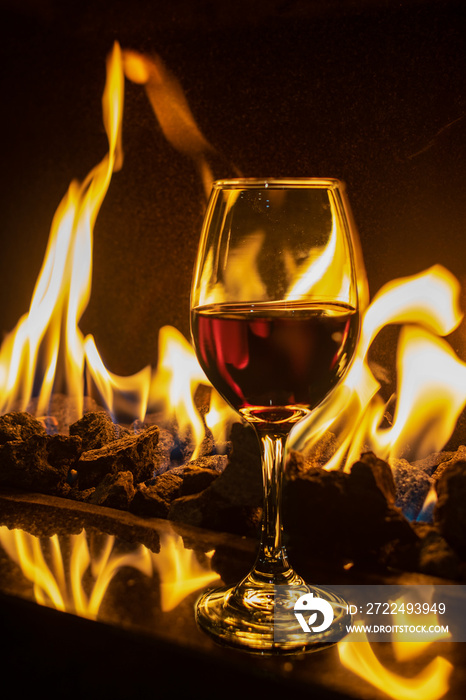 Single red wine glass on fireplace