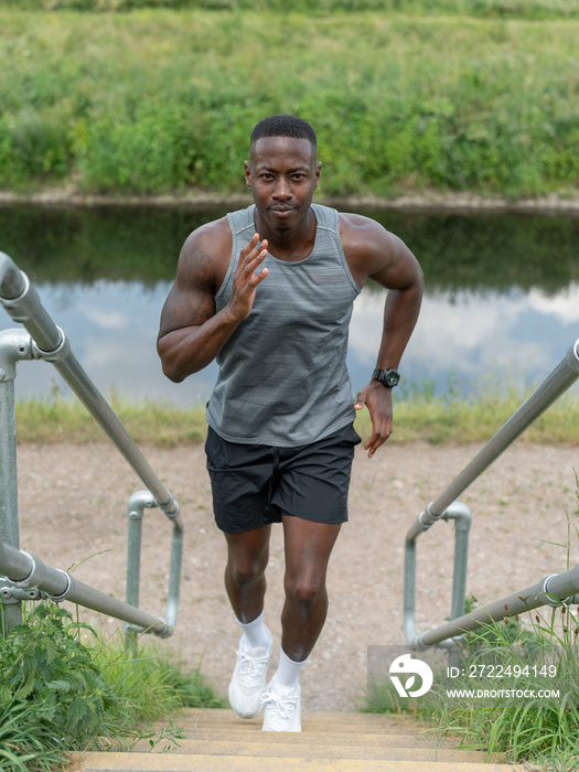 Man exercising outdoors running up stairs