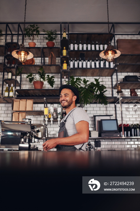 Young business owner standing in a cafe