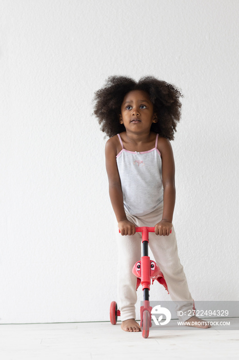 Portrait of girl on tricycle