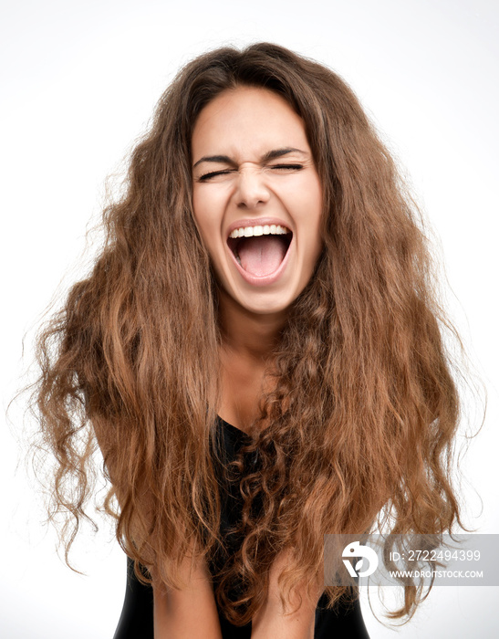 Curly brunette woman happy laughing excited looking up with closed eyes