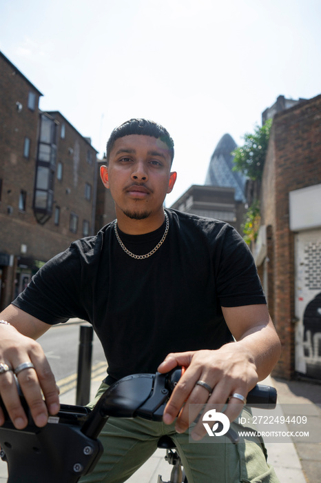 Man sitting on bike and looking at camera