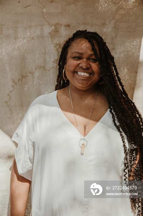 portrait of a plus size Afro Latinx Haitian American woman smiling and looking