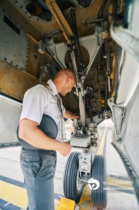 Airline captain examining the landing gear system