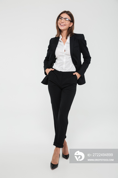 Full length portrait of a happy cheerful businesswoman in suit