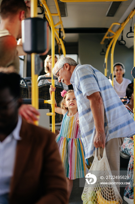 Granddaughter traveling with grandparent by bus