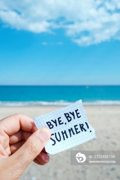 man on the beach and text bye bye summer in a note