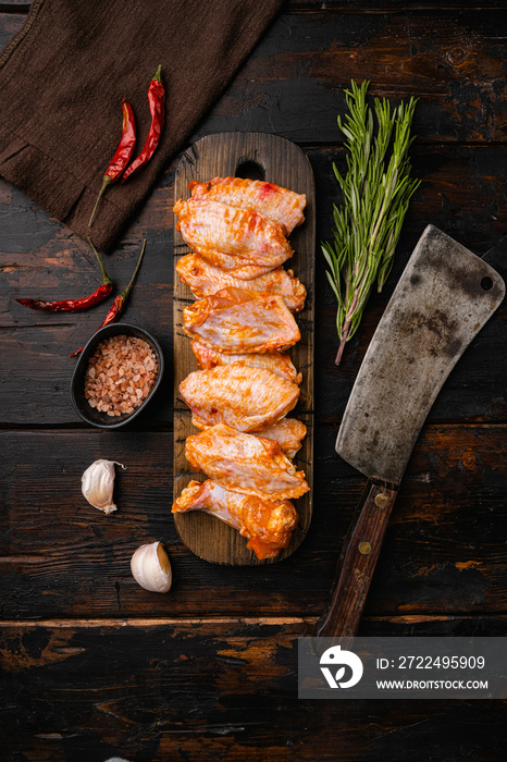 Chicken wings Raw marinated prepared in Asian style, on old dark  wooden table background, top view flat lay