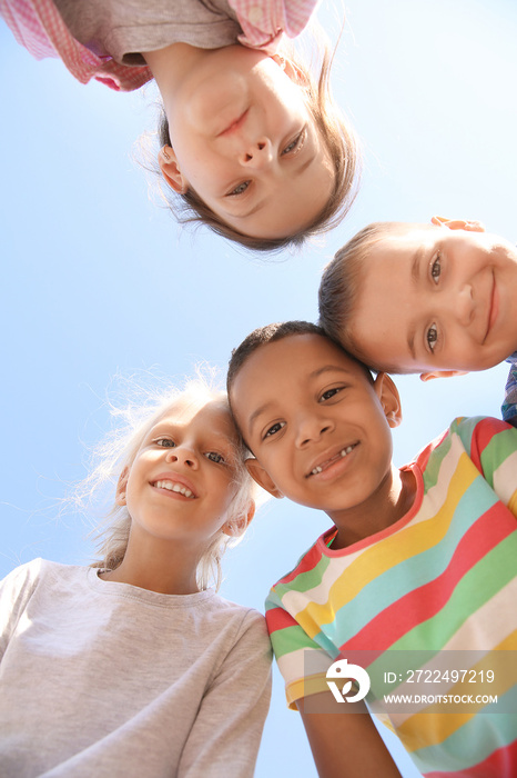 Portrait of cute little children outdoors, bottom view